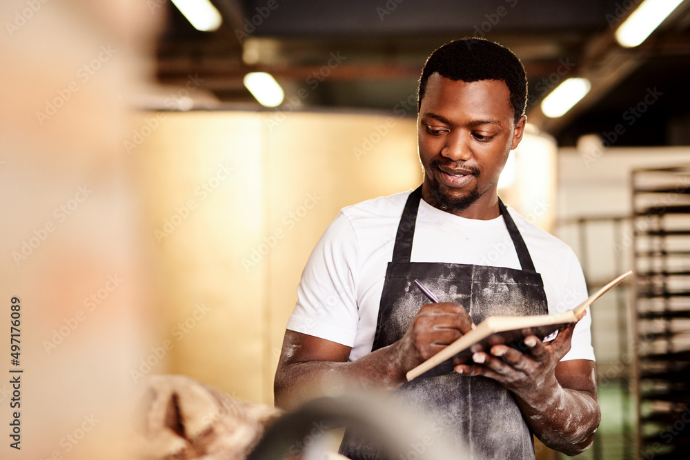 Aufkleber i just finished all my big orders for the day. cropped shot of a male baker making notes while worki