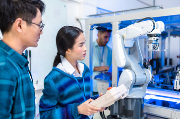 Meeting asian Engineers Maintenance Robot Arm at Lab. they are in a High Tech Research Laboratory...