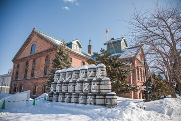 Historical Building of Sapporo Beer Museum in winter, snowy day - obrazy, fototapety, plakaty