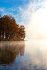 View of Foggy Lake with Fall Trees with Foliage 