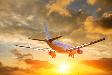 Fototapeta na wymiar Airplane in the sunset sky. travel concept.