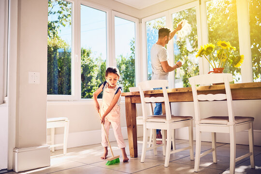 Helping Dad With Some Spring Cleaning Around The House. Shot Of A Father And His Little Daughter Doing Chores Together At Home.