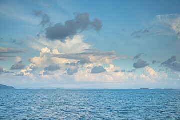 Cargo ship on horizon, clear sky