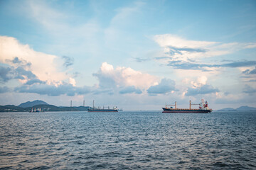 Cargo ship on horizon, clear sky