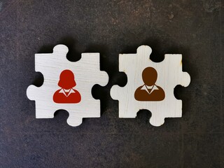 Teamwork and partnership concept. Human icons on wooden jigsaw puzzle pieces.