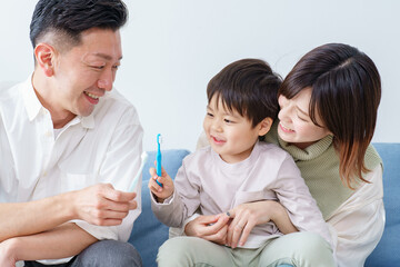 Parents and child brushing teeth