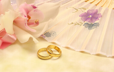 Fototapeta na wymiar Pink Orchid and Wedding Rings Close up