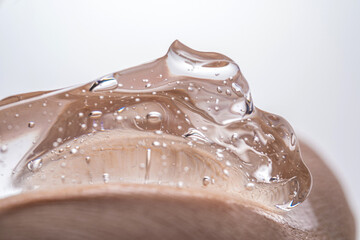 The texture of a thick cosmetic hyaluronic gel on the skin.