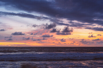 Naklejka na ściany i meble Beautiful bright colored sunset on the ocean.