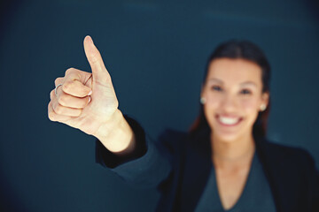 Positive attitudes make successful businesses. Portrait of a young businesswoman showing a thumbs...