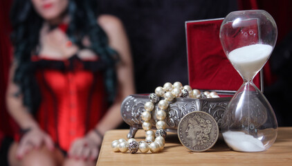 Vintage Jewelry Box with hourglass and Silver Dollar woman in corset in background
