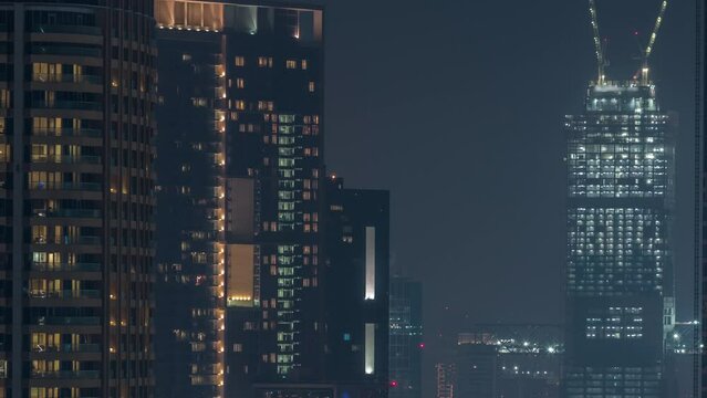 Cranes working on modern constraction site works of new skyscraper timelapse