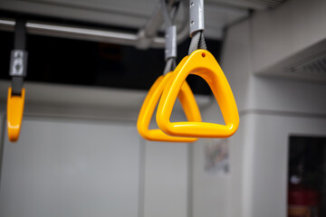 Public transport in the city. Moscow Metro. Yellow handrails for hands close-up. An empty subway car lately in the evenings. There are few people in a modern subway car.