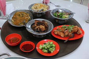 Various meals have been prepared on the round table and are ready to eat