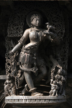 Stone Sculpture of Beautiful Female (Madanikas) with selective focus, 12th century Hindu temple, Ancient stone art and sculptures in each pillars, Chennakeshava Temple, Belur, Karnataka, India.