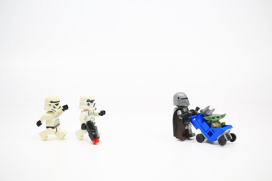 Hong Kong - April 4 2022:minifigure act like  The Mandalorian take care his baby yoda