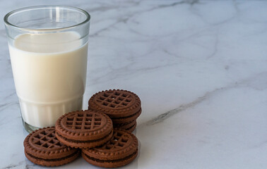 Chocolate chip cookies with milk on a light background. Chocolate sandwich - cookies.
