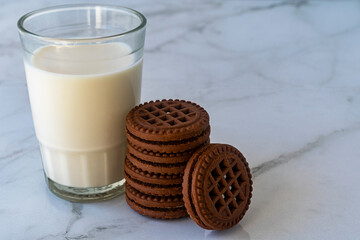 Chocolate chip cookies with milk on a light background. Chocolate sandwich - cookies.