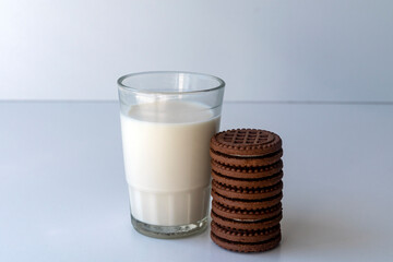 Chocolate chip cookies with milk on a light background. Chocolate sandwich - cookies.