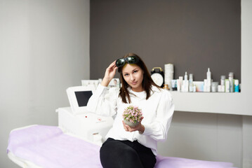 portrait of a young woman in a salon of laser epilation