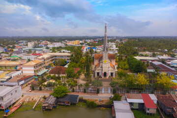 Fototapeta na wymiar Aerial view of the famous Cai Be church in the Mekong Delta, Roman architectural style. In front is Cai Be floating market, Tien Giang, Vietnam.