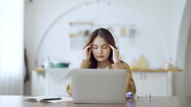 Office syndrome concept. Overworked tired young asian woman feeling headache, having eyesight problem after computer laptop work. Stressed adult business woman suffering from fatigue at home