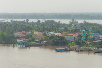 Fototapeta premium View of My Tho city, Tan Long island and marina, Rach Mieu bridge with transportation, energy power infrastructure in Mekong Delta, day and night.