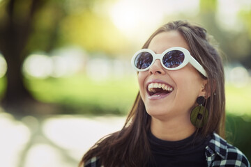 Freedom and laughter. Cropped shot of an attractive young woman spending the day outdoors.