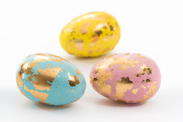 Three decorative Easter eggs against a white background. Easter eggs are traditionally given at Easter. 