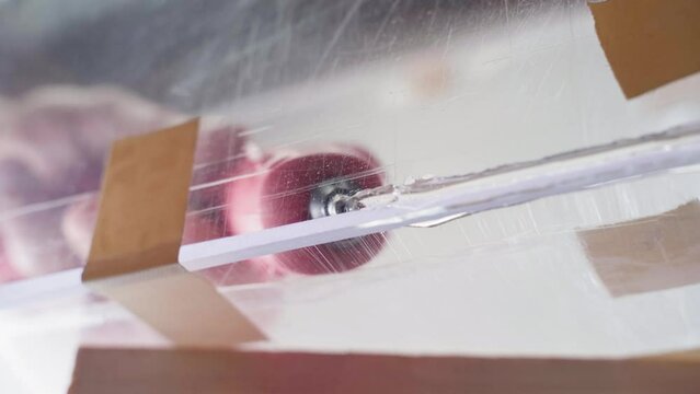 Gluing transparent plexiglass with hot glue from a glue gun, bottom view