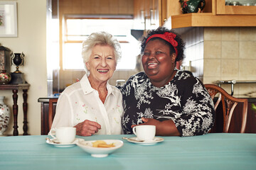 Loving this visit from my very dear old friend. Portrait of a happy senior woman having tea with...
