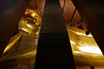 The giant reclining Buddha golden statue is seen at Wat Pho temple complex, also known as Wat Phra Chetuphon, in Bangkok, Thailand.