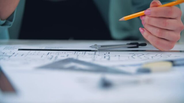 4k slow motion video of close up engineer hand sketching a construction project.