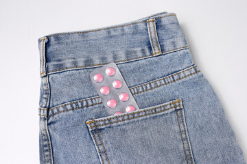 Pills in the pocket of blue jeans, the concept of impotence