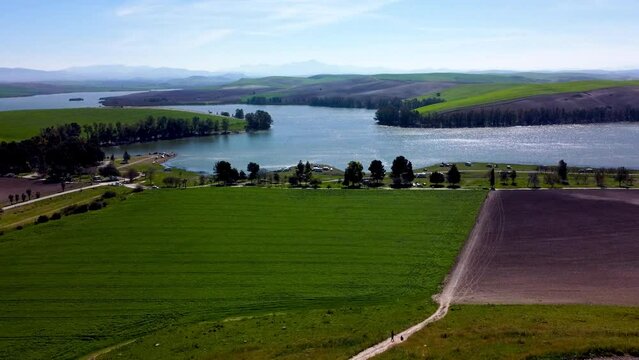 Aerial view of the Torre del Aguila reservoir in Palmar de Troya, Seville, Spain on a clear day.