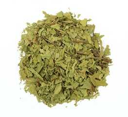 Dried lovage, famous culinary herb, lat. Levisticum officinale. Heap of dried lovage on the white background, flat lay.