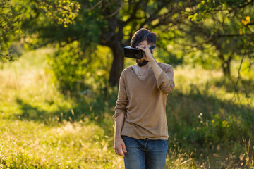 man wearing virtual reality glasses outdoors