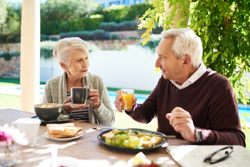 This type of love is forever. Shot of an affectionate senior couple enjoying a meal together outdoors.