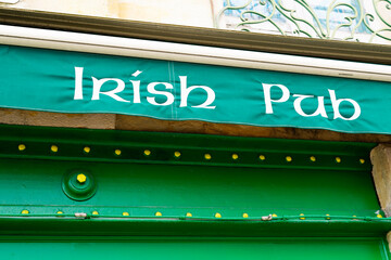 text irish pub on facade wall front building cafe bar in street