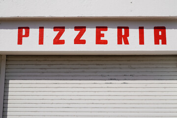 Pizza pizzeria restaurant red sign old vintage on street outside view of rustic text on wall facade