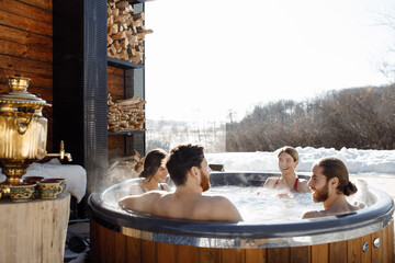 Friends of Caucasian appearance are resting in a country house, jacuzzi, nature and leisure, view...