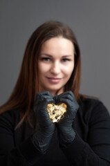 young woman holding a heart shaped garland in her hands