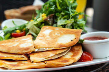 Delicious Mexican beef quesadillas with fresh lettuce and guacamole sauce