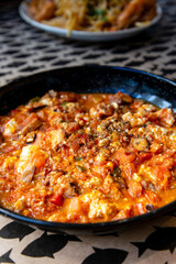 Scrambled eggs with fresh avocado and salmon served on two toasts  wheat bread with fresh lettuce on white plate for a healthy breakfast