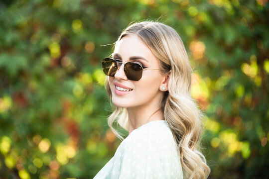 Close up face of young stylish woman in sunglasses. Beautiful fashionable girl outdoor portrait. Lifestyle, walk outdoors, enjoying life, positivity.