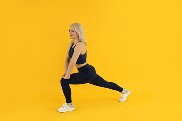 Fototapeta na wymiar Concept of healthy lifestyle with sporty woman on yellow background