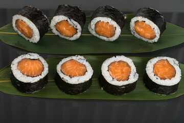 big rolls with red fish on a dark background
