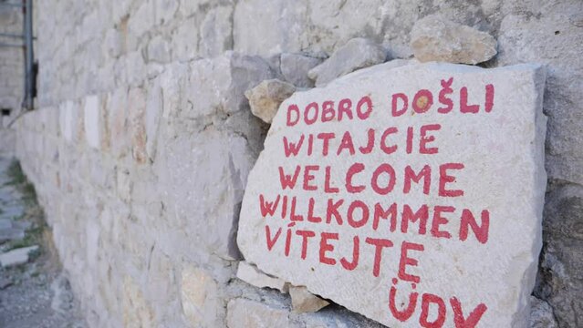Welcome sign on rock in Omis fort.