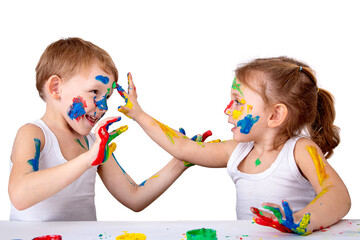 Small children draw on each other with finger paints on a white background