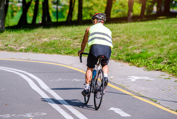 Fototapeta premium Cyclist ride on the bike path in the city Park 